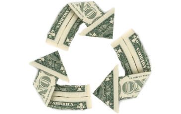 Dollar bills arranged in the recycle symbol