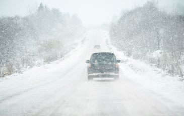 Car driving on a snow covered road